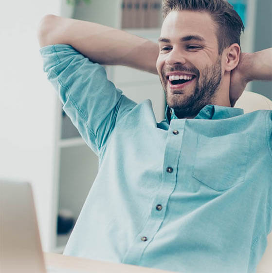 happy man at computer_560x560px